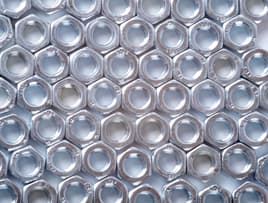 Die cast metal nuts laying in a pattern