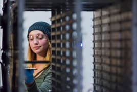 Plant employee putting parts into sintering machine